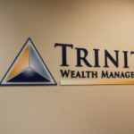 Painted laser-cut acrylic letters with digitally-printed accents for Trinity Wealth Management in Berwyn, PA